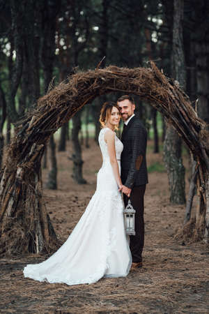 walk of the bride and groom through the autumn forest in Octoberの写真素材
