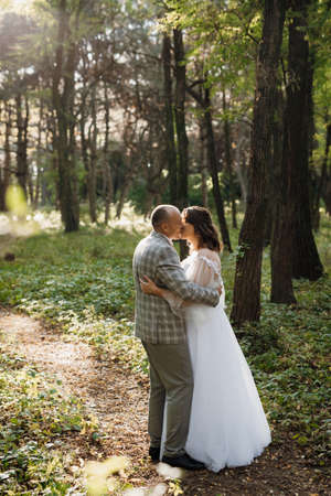 walk of the bride and groom through the autumn forest in Octoberの写真素材