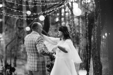 man and woman got engaged in autumn forest at wedding decorated ceremonyの写真素材