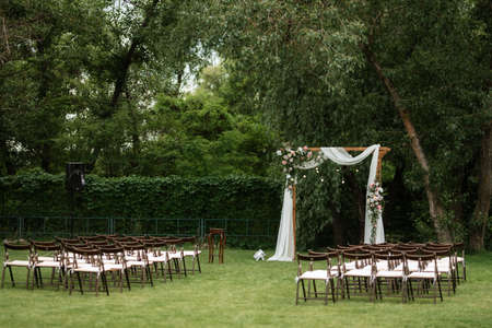 wedding ceremony area with dried flowers in a meadow in a pine brown forestの写真素材