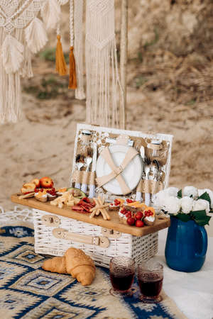 picnic in nature with a basket of delicious productsの写真素材