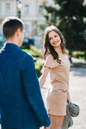 guy and a girl happily walk in the morning on the empty streets of old Europeの写真素材