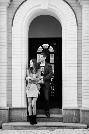 guy and a girl happily walk in the morning on the empty streets of old Europeの写真素材