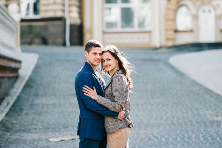 guy and a girl happily walk in the morning on the empty streets of old Europe