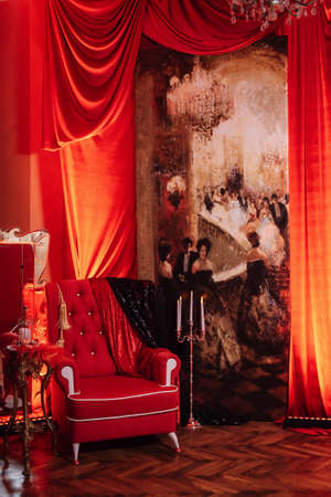 photo zone with a red armchair in a red design against the background of the picture