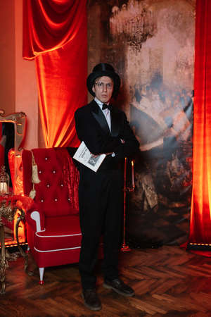 theater actor in a black top hat in the retro atmosphere of a merchant's houseのeditorial素材