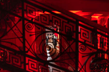 old antique spiral staircase leading upwards against the background of a glowing windowのeditorial素材