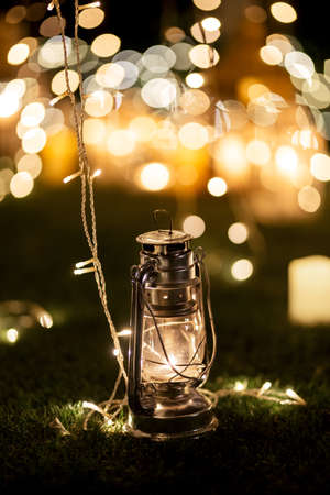 burning candles on a dark night in a wooden lantern as a decoration for a holiday