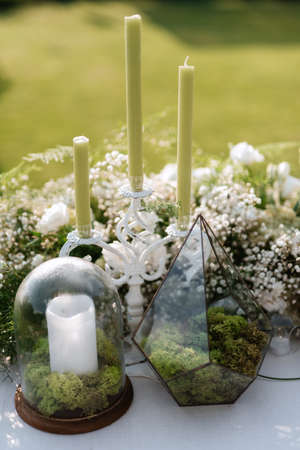 burning candles on a dark night in a wooden lantern as a decoration for a holidayの写真素材
