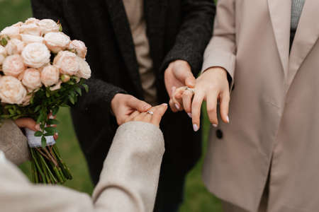 the bride and groom tenderly hold hands between them love and relationships