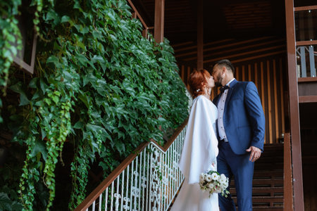 bride in a white dress with a bouquet and the groom in a blue suit on their wedding dayの写真素材
