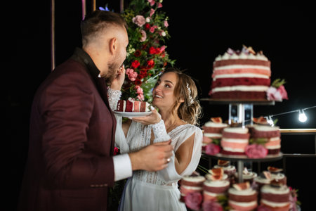 newlyweds happily cut, laugh and taste the wedding cake