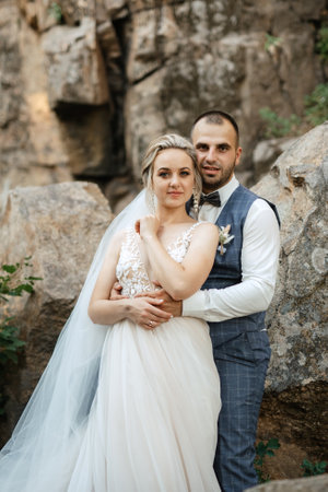 the groom and the bride are walking in the forest on a bright day