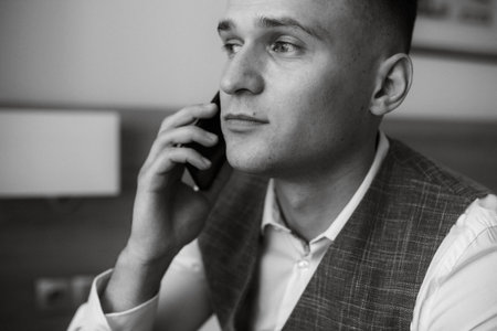 portrait of the groom in a light gray suit indoorsの写真素材