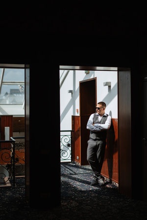 portrait of the groom of a man in the morning before the wedding in a gray plaid three-piece suitの写真素材