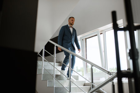 portrait of smiling groom with beard in blue color suitの写真素材