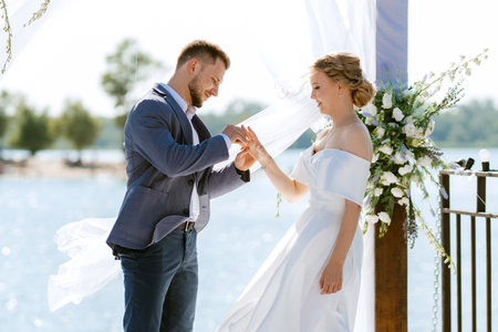 wedding ceremony on a high pier near the river with invited guestsの写真素材