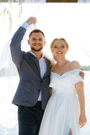 wedding ceremony on a high pier near the river with invited guestsの写真素材