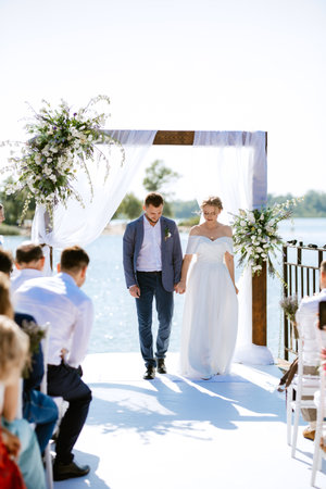 wedding ceremony on a high pier near the river with invited guestsの写真素材