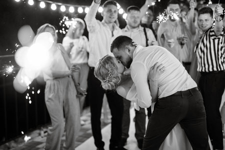 newlyweds at a wedding in the corridor of sparklers