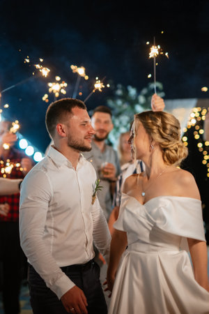 newlyweds at a wedding in the corridor of sparklers