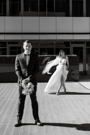bride and groom first meeting on the roof of a glass skyscraperの写真素材