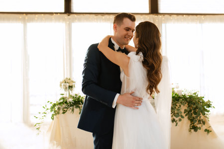 the first dance of the bride and groom inside a restaurant with heavy smokeの写真素材
