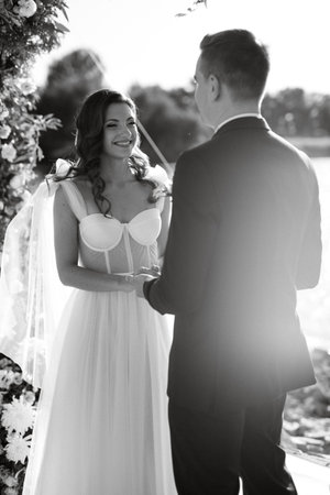 wedding ceremony on a high pier near the river with invited guestsの写真素材