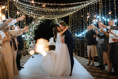 newlyweds happily cut, laugh and taste the wedding cakeの写真素材