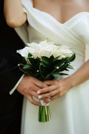 the first meeting of the bride and groom in wedding outfits in the parkの写真素材