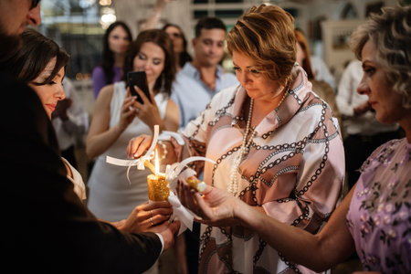 transfer of wedding fire with the help of candles from mothers to the newlywedsの写真素材
