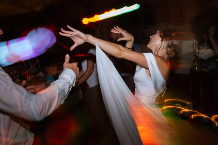 the first dance of the bride and groom inside a restaurant with heavy smokeの写真素材