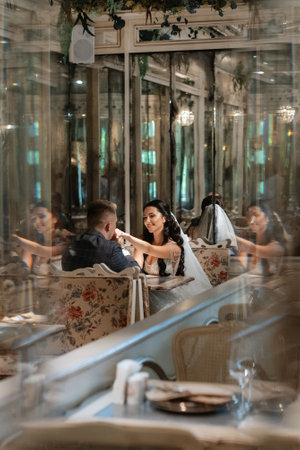 bride and groom inside a cocktail bar in a bright atmosphere with a glass of drinkの写真素材