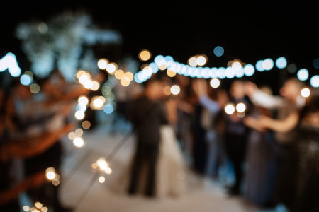 newlyweds at a wedding in the corridor of sparklersの写真素材
