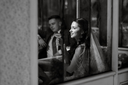 portrait of a bride in a white dress in a bright cafe with mirrorsの写真素材