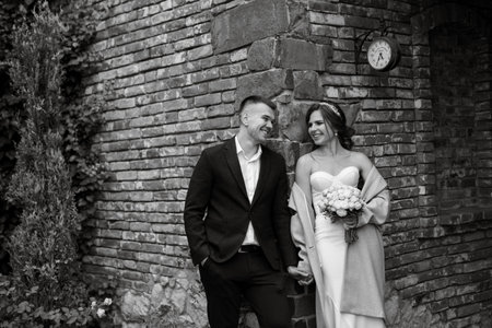 portrait of a young couple of bride and groom on their wedding day in a country cottageの写真素材