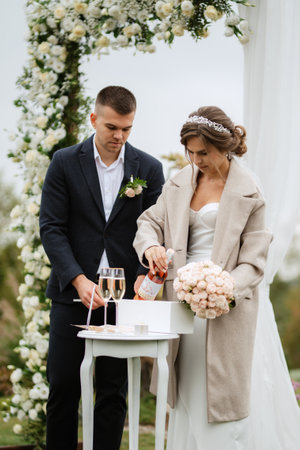 wedding ceremony of the newlyweds in a country cottage on a green hillの写真素材
