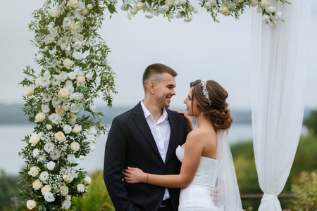 wedding ceremony of the newlyweds in a country cottage on a green hillの写真素材