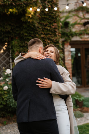the first wedding dance of the bride and groom inside the restaurant hall in sunset lightの写真素材