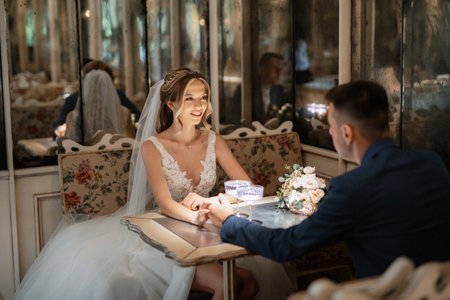 bride and groom inside a cocktail bar in a bright atmosphere with a glass of drinkの写真素材