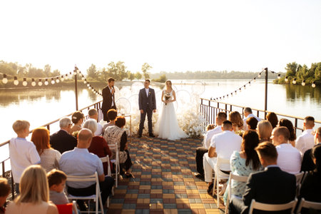 wedding ceremony of the newlyweds on the pier near the restaurantの写真素材