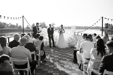 wedding ceremony of the newlyweds on the pier near the restaurantの写真素材