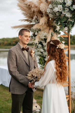 wedding ceremony of the newlyweds in a country cottage on a green hillの写真素材