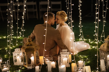 night wedding ceremony of the newlyweds in a country cottage on a green hillの写真素材