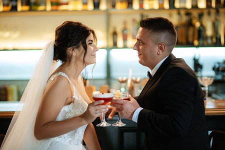 bride and groom inside a cocktail bar in a vibrant atmosphereの写真素材