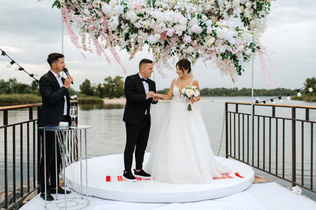 wedding ceremony of the newlyweds on the pier near the restaurantの写真素材