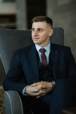 portrait of a cheerful groom in a blue suit in the studioの写真素材