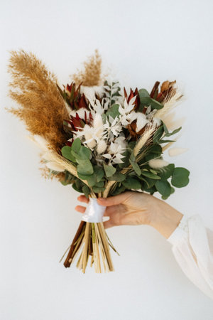 elegant wedding bouquet of fresh natural flowers and greeneryの写真素材