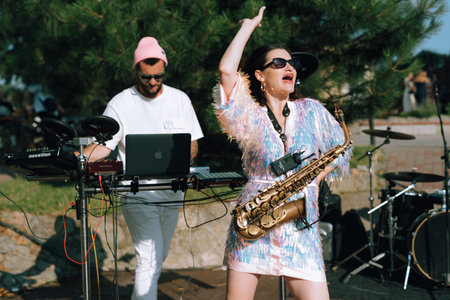 guy musician plays the drum at a concert in stage lightingの写真素材