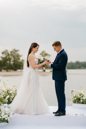 wedding ceremony of the newlyweds on the pier near the restaurantの写真素材